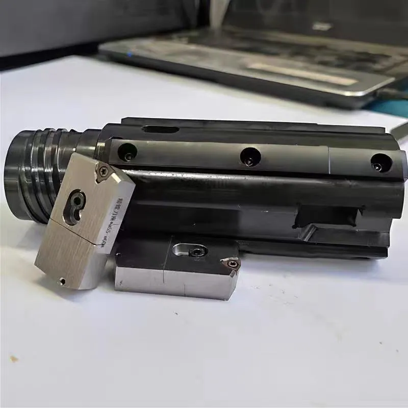 Close-up of a deep-hole machining tool assembly and replaceable cutting inserts