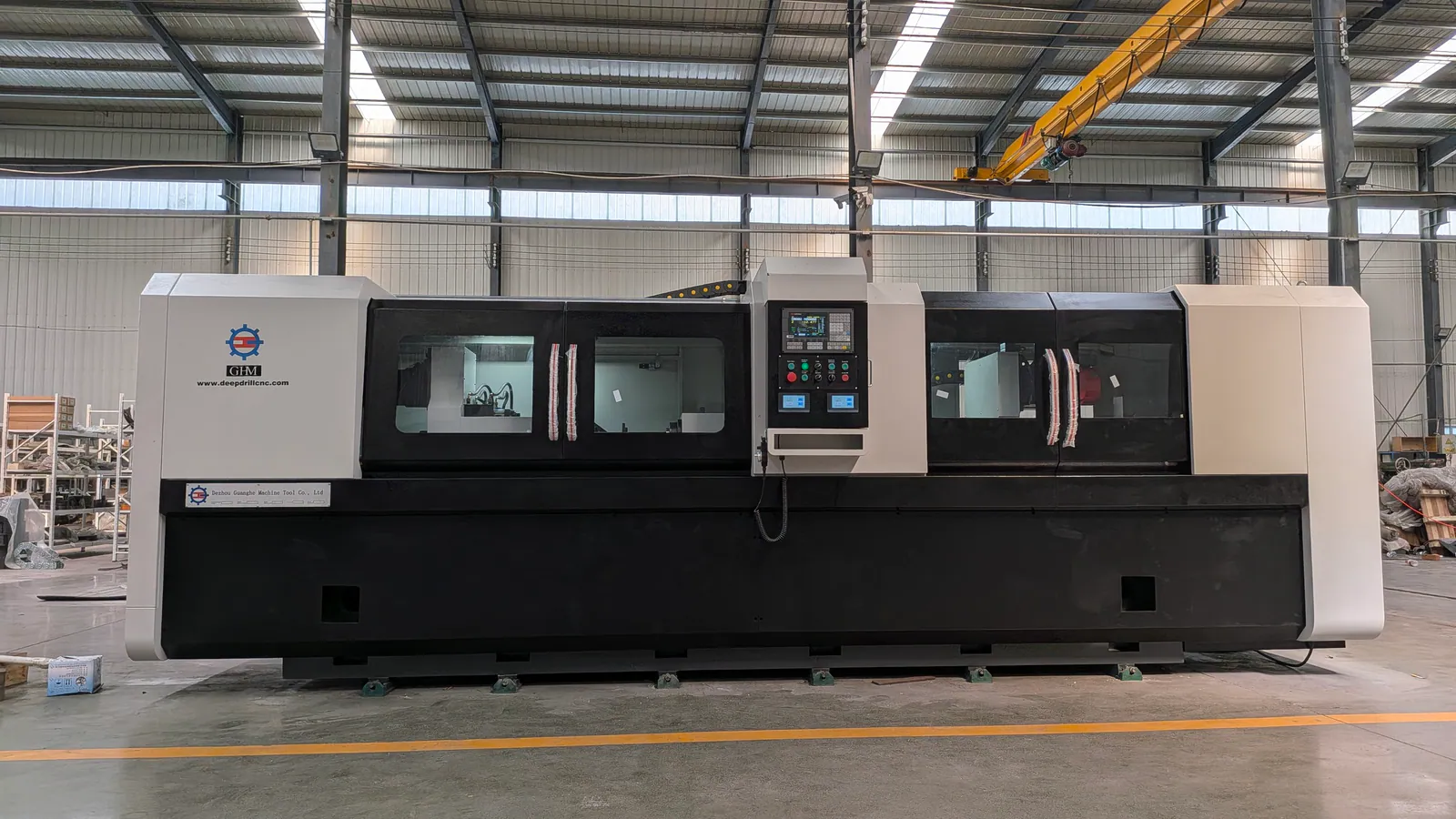 Front view of an enclosed Guanghe dual-spindle CNC deep-hole machine in the workshop