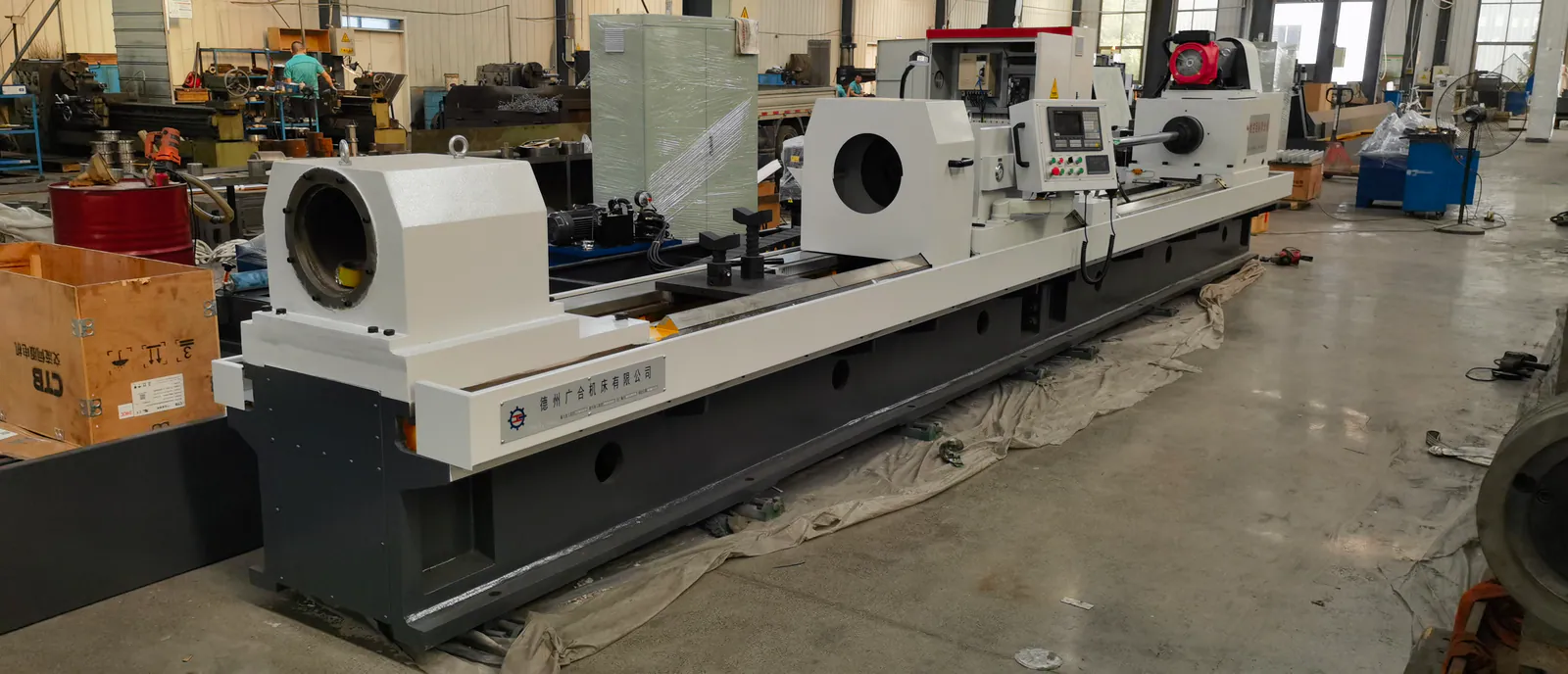 Front-left workshop view of a Guanghe CNC skiving and roller burnishing machine